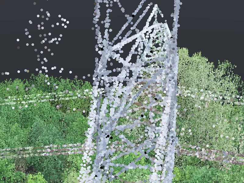 Drone camera view of a lattice tower standing among trees